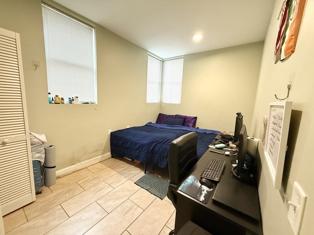 299 Dudley Street, Unit 2 Boston, MA 02119 - Photo 6 of 6 a bedroom with a bed and dresser