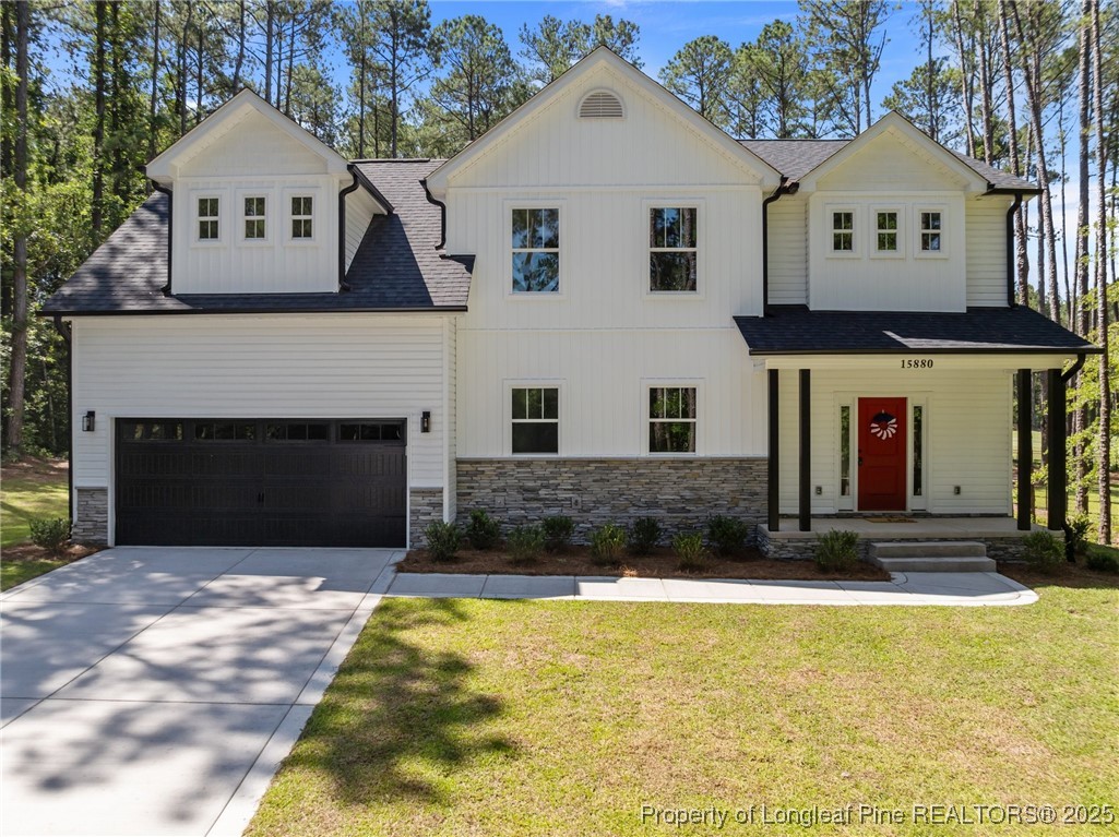 a view of a white house with a large yard and large trees