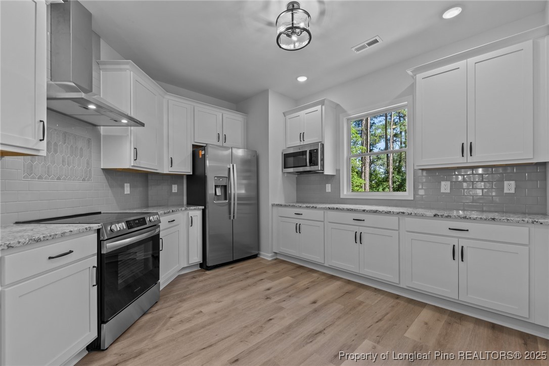 15880 Fox Lane Wagram, NC 28396 - Photo 11 of 33 a kitchen with granite countertop a sink stainless steel appliances and counter space