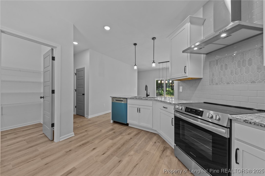 15880 Fox Lane Wagram, NC 28396 - Photo 13 of 33 a kitchen with stainless steel appliances granite countertop a stove a sink and a refrigerator