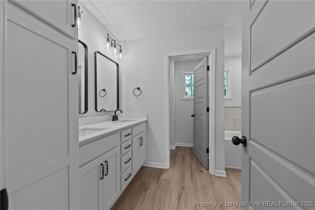 15880 Fox Lane Wagram, NC 28396 - Photo 17 of 33 a bathroom with a double vanity sink and mirror with shower
