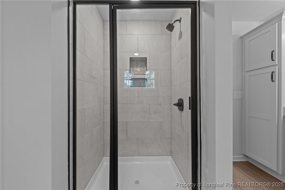 15880 Fox Lane Wagram, NC 28396 - Photo 18 of 33 a bathroom with a glass shower door