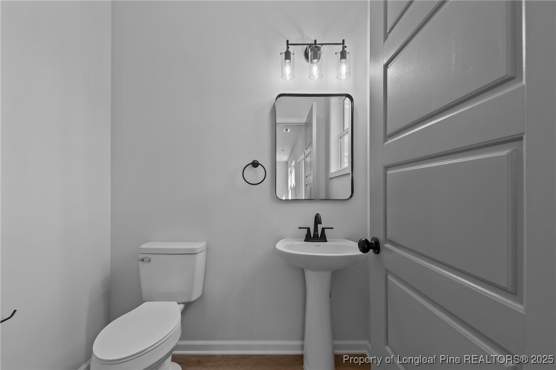 15880 Fox Lane Wagram, NC 28396 - Photo 26 of 33 a bathroom with a toilet sink and mirror