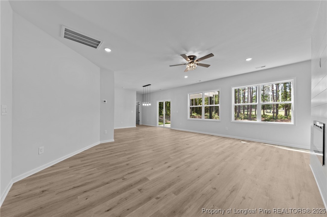 15880 Fox Lane Wagram, NC 28396 - Photo 6 of 33 a view of an empty room with a window and wooden floor