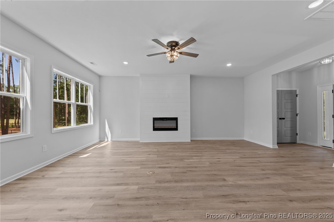 15880 Fox Lane Wagram, NC 28396 - Photo 7 of 33 a view of an empty room with a window and wooden floor