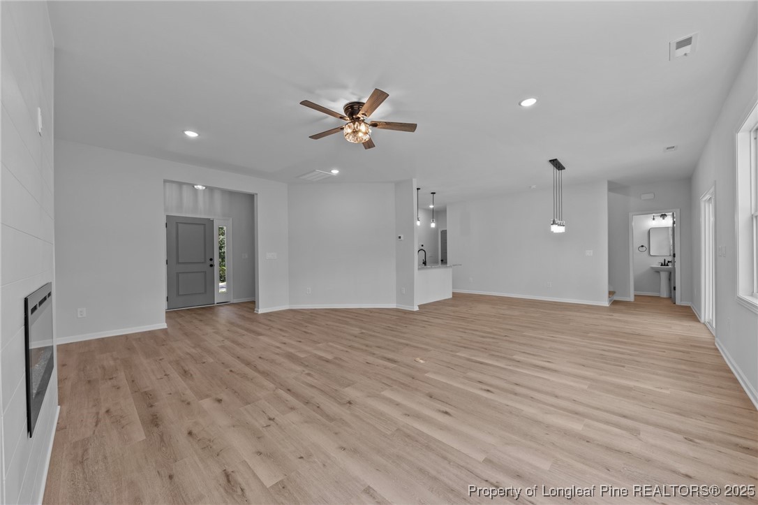 15880 Fox Lane Wagram, NC 28396 - Photo 8 of 33 a view of a big room with wooden floor and a ceiling fan