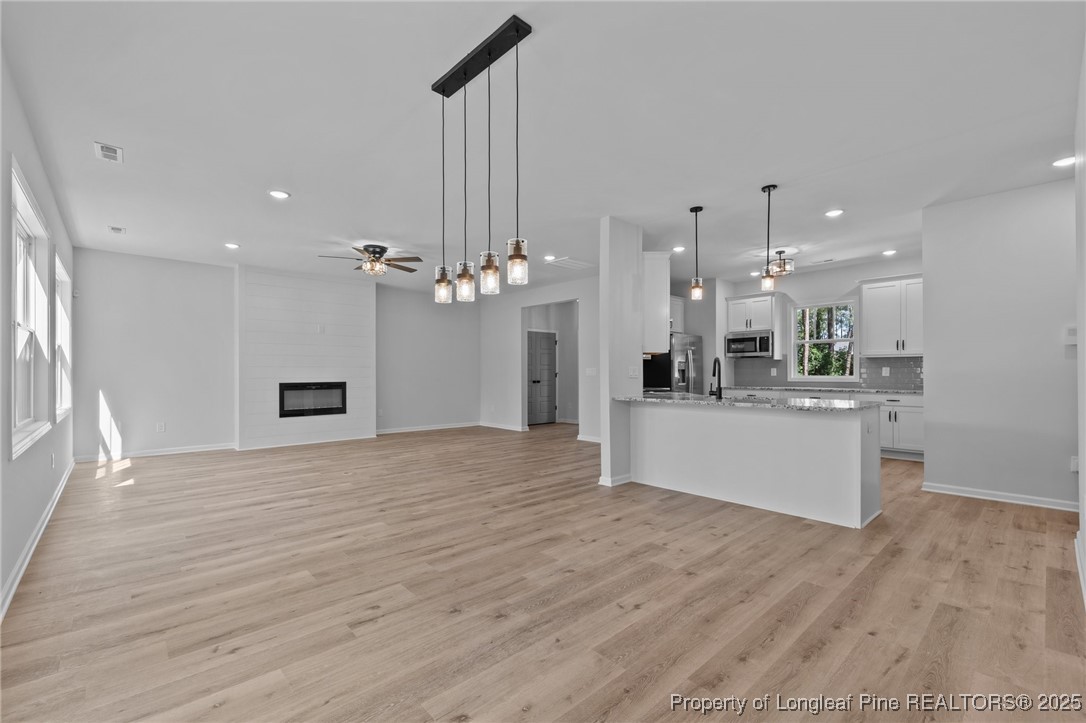 15880 Fox Lane Wagram, NC 28396 - Photo 9 of 33 a view of a kitchen with a sink wooden floor and a kitchen