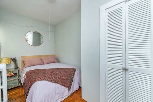 a bedroom with a bed and a lamp