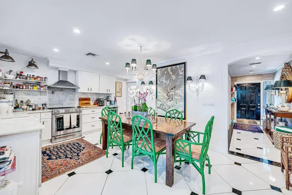 a kitchen that has a lot of cabinets in it and wooden floors