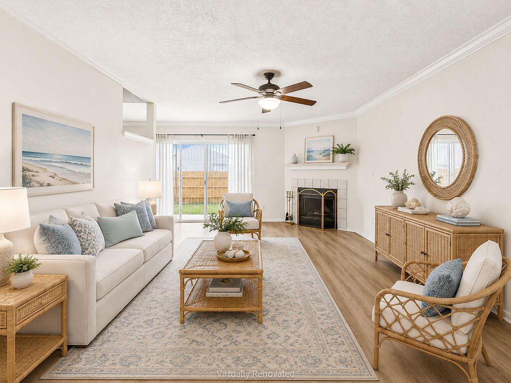53 4th Street Shalimar, FL 32579 - Photo 5 of 47 a living room with furniture a fireplace a flat screen tv and a large window