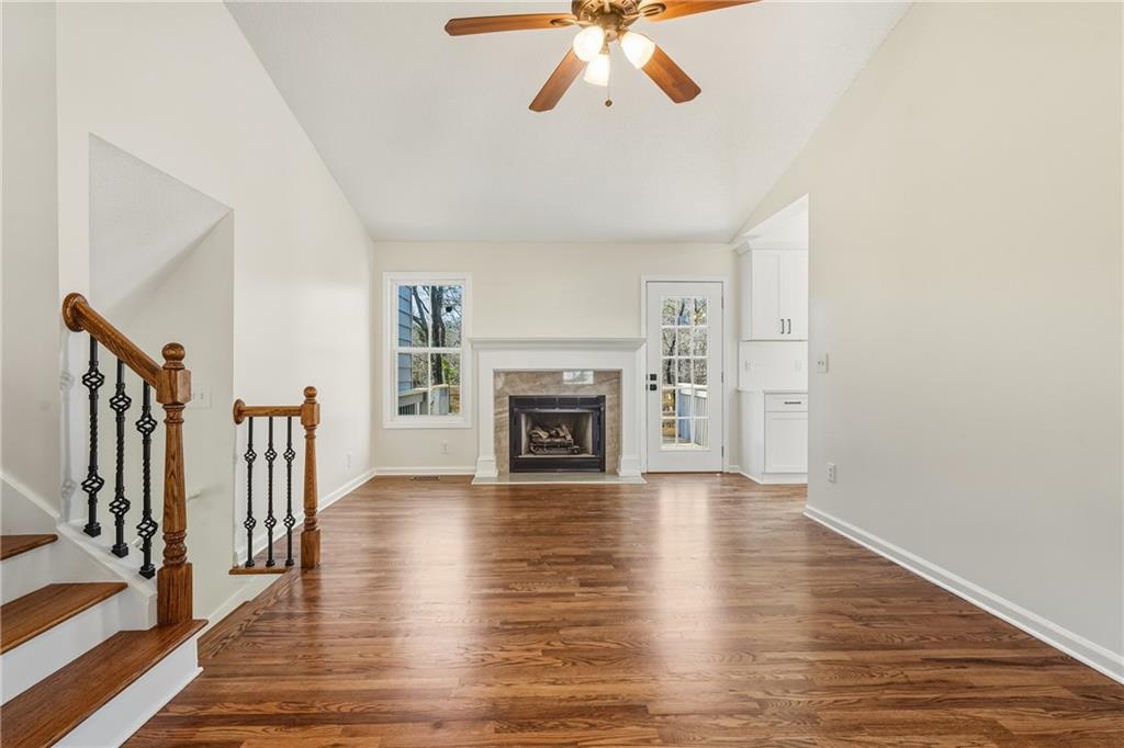 615 Amberwood Place Euharlee, GA 30145 - Photo 12 of 37 a view of an empty room with wooden floor fireplace and a window