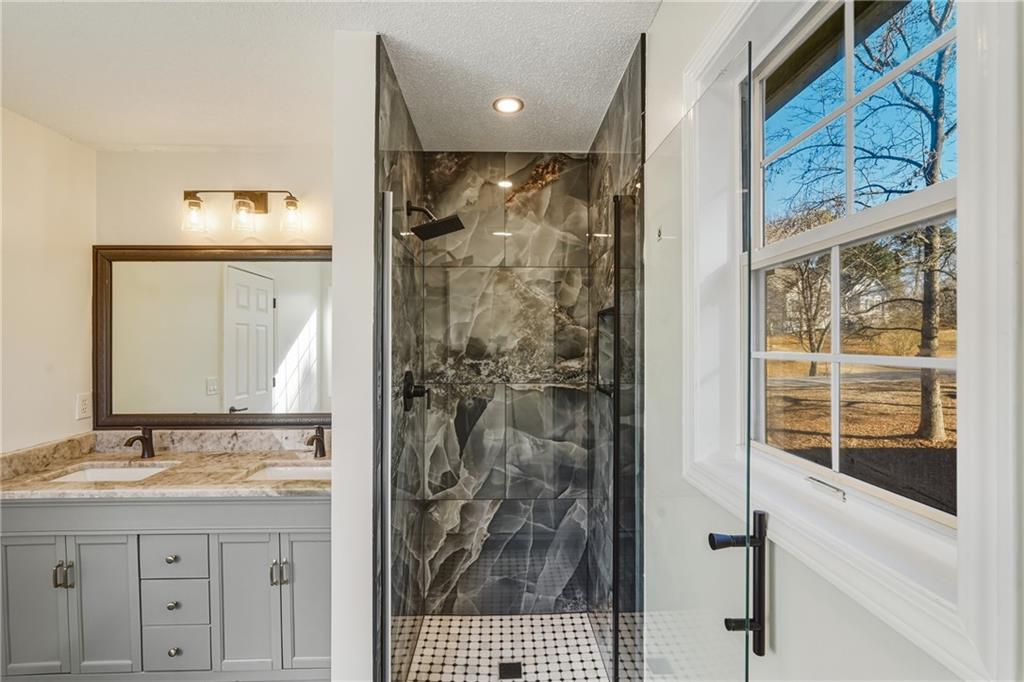 615 Amberwood Place Euharlee, GA 30145 - Photo 18 of 37 a bathroom with a shower a sink and a mirror