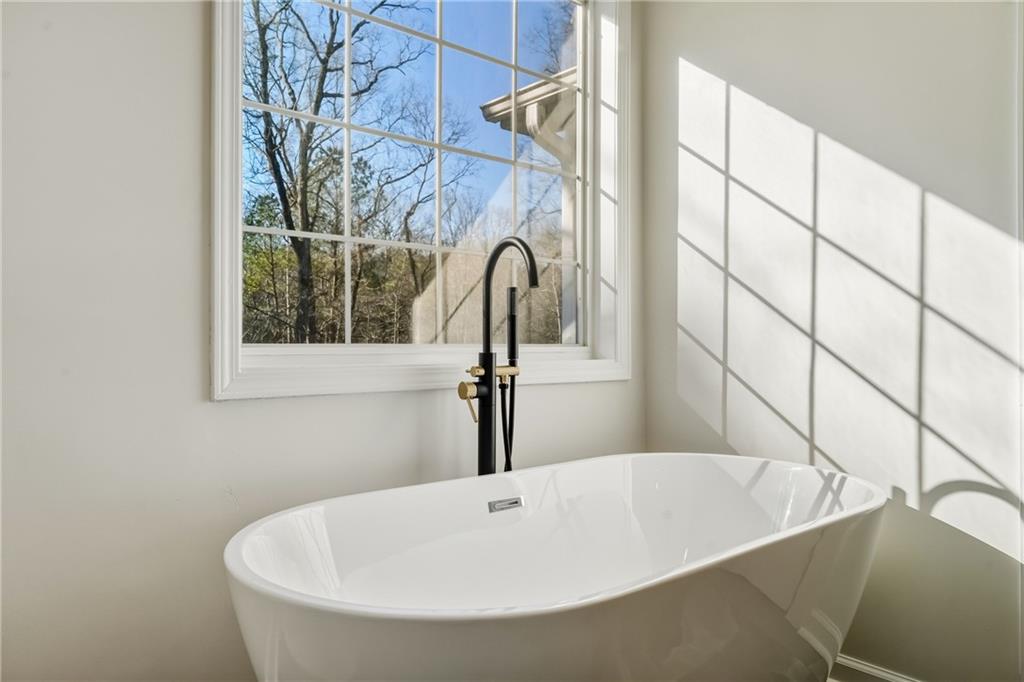 615 Amberwood Place Euharlee, GA 30145 - Photo 19 of 37 a bathroom with a bathtub and a window