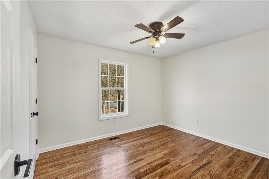615 Amberwood Place Euharlee, GA 30145 - Photo 24 of 37 a view of empty room with wooden floor and fan