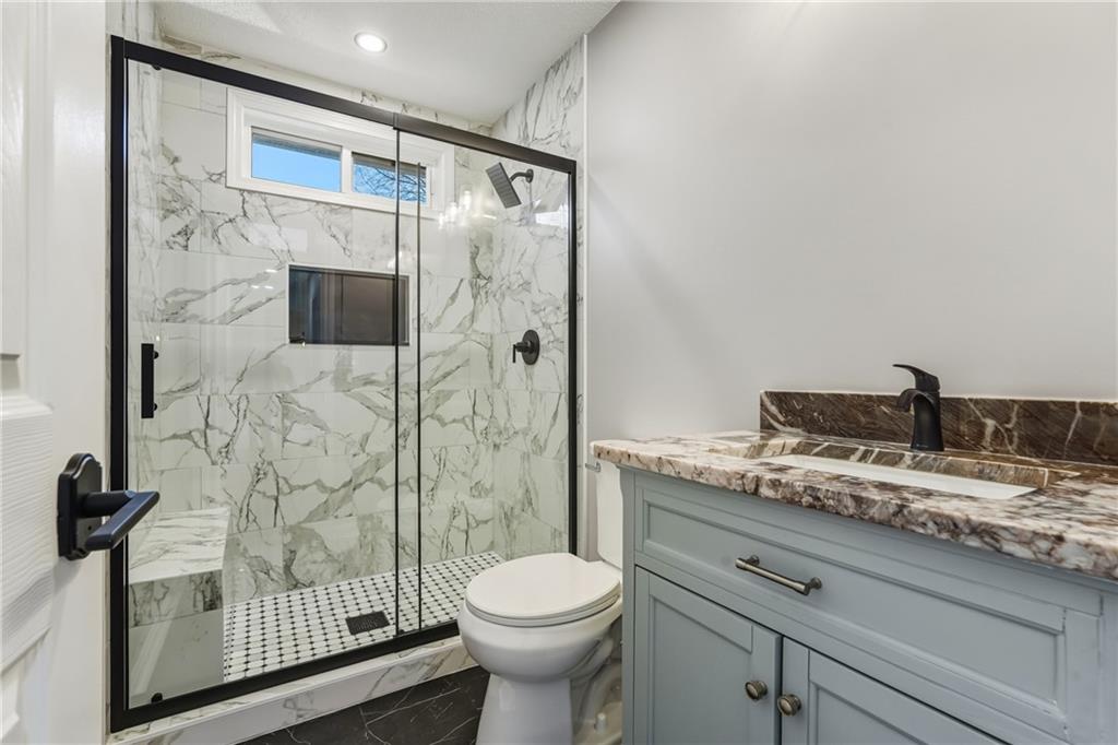 615 Amberwood Place Euharlee, GA 30145 - Photo 25 of 37 a bathroom with a granite countertop sink toilet and shower
