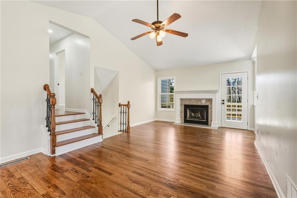 615 Amberwood Place Euharlee, GA 30145 - Photo 3 of 37 a view of an empty room with wooden floor and a fireplace