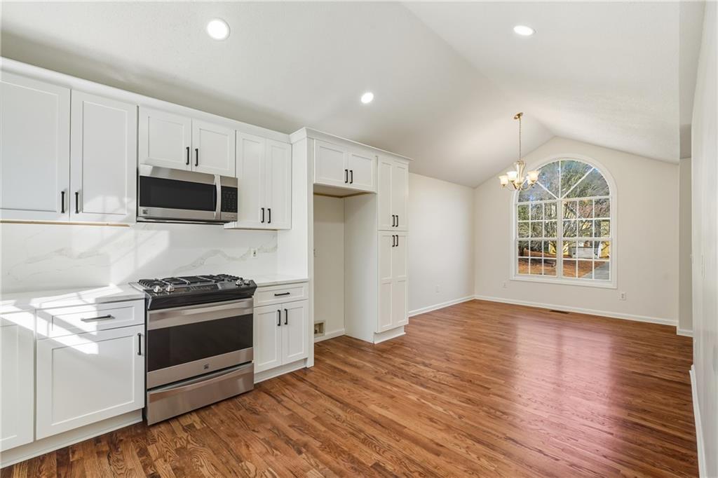 615 Amberwood Place Euharlee, GA 30145 - Photo 7 of 37 a kitchen with stainless steel appliances a stove a sink and a microwave