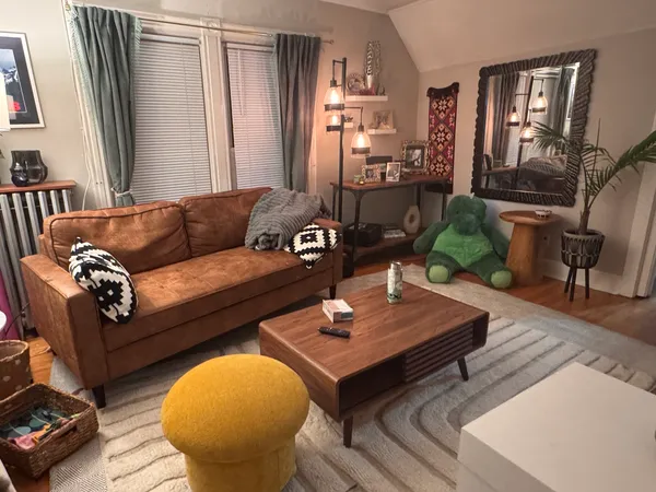 a living room with furniture and wooden floor