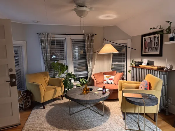 a living room with furniture and a chandelier