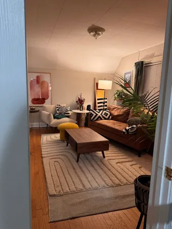 a living room with furniture and a lamp