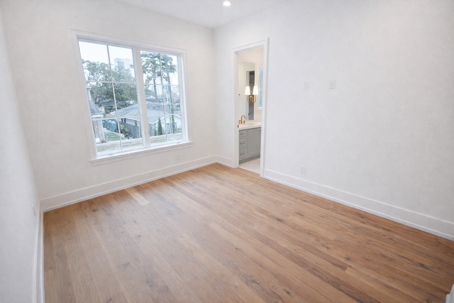 4107 Whitman Street Houston, TX 77027 - Photo 18 of 29 an empty room with wooden floor and windows