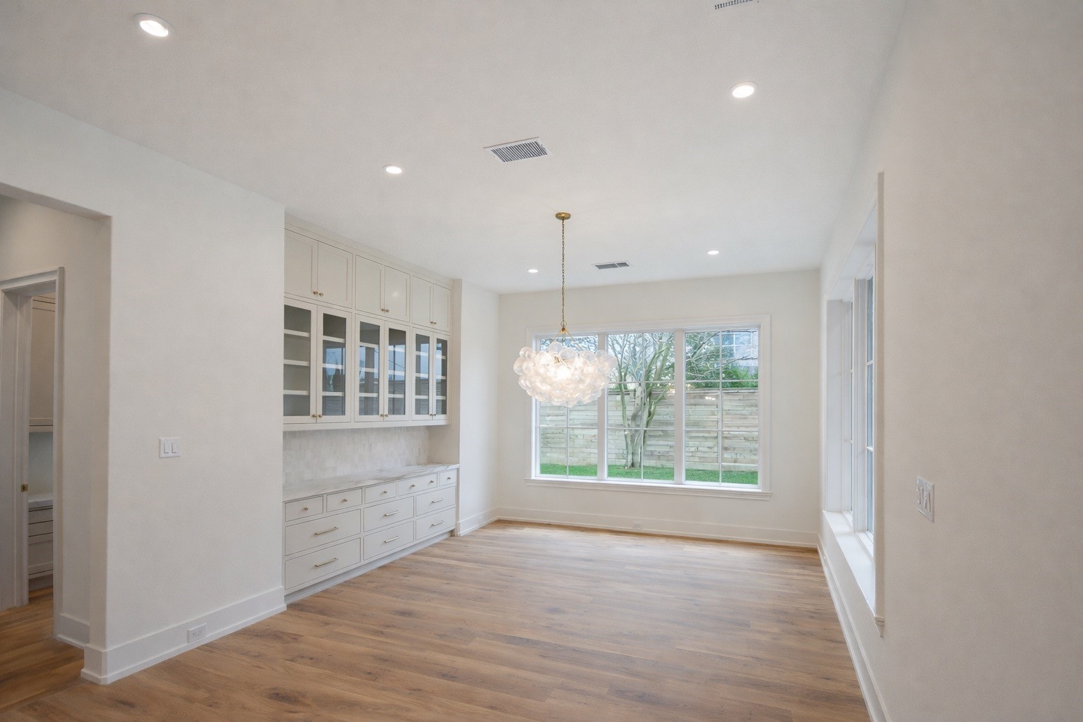 4107 Whitman Street Houston, TX 77027 - Photo 9 of 29 a view of an empty room with a window and wooden floor