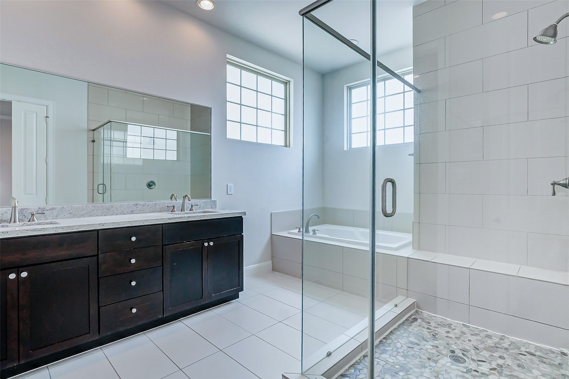 2209 Chenevert Street, Unit C Houston, TX 77003 - Photo 15 of 26 a spacious bathroom with a double vanity sink a large mirror and a bathtub