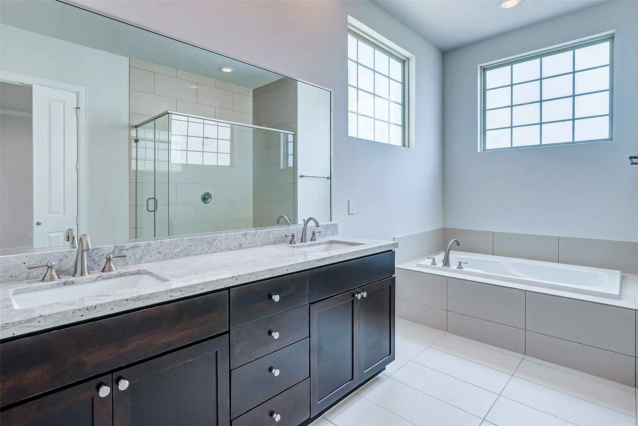 2209 Chenevert Street, Unit C Houston, TX 77003 - Photo 17 of 26 a bathroom with a tub a sink double vanity and window