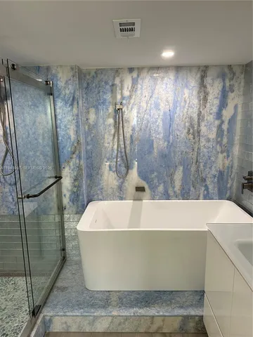 a white bath tub sitting in a bathroom