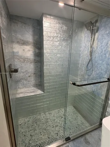 a bathroom with a glass shower door