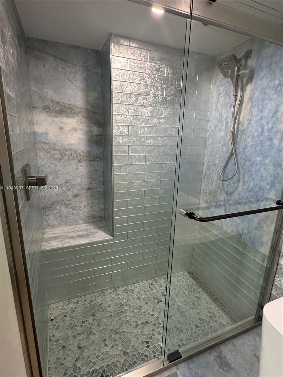 555 Northeast 15th Street, Unit TSA Miami, FL 33132 - Photo 12 of 24 a bathroom with a glass shower door