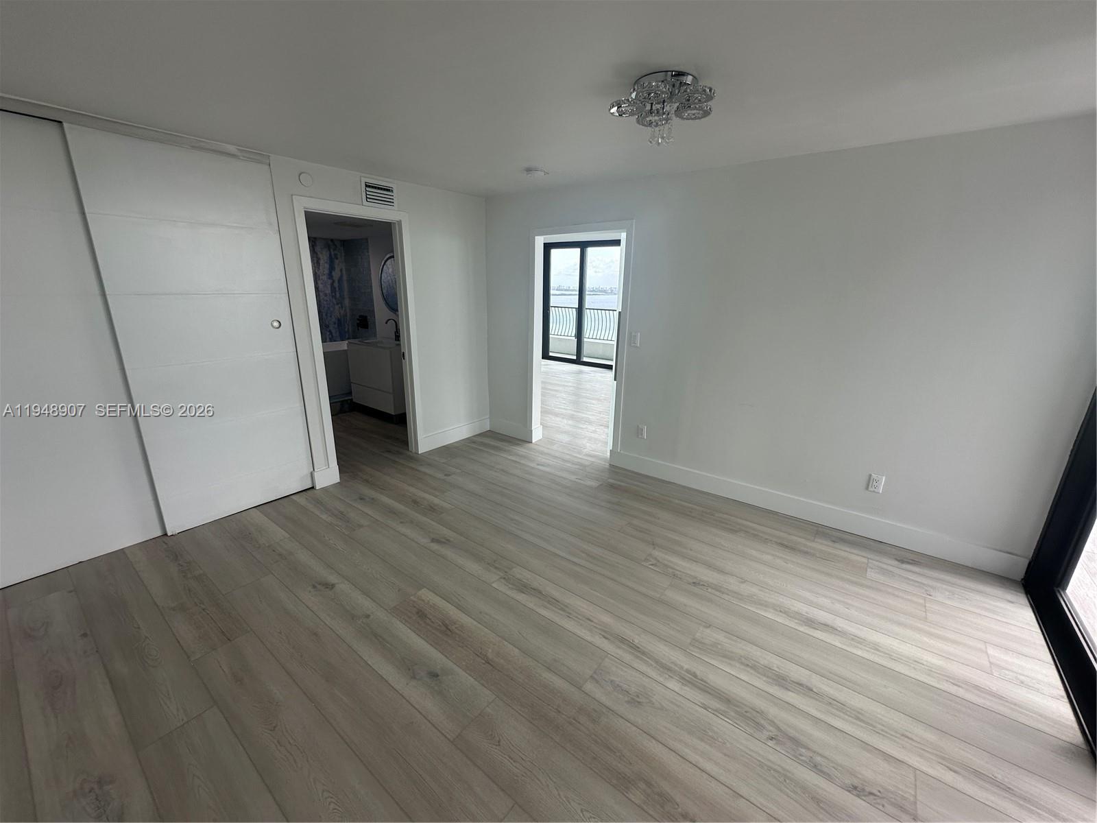 555 Northeast 15th Street, Unit TSA Miami, FL 33132 - Photo 13 of 24 a view of empty room with wooden floor and fan