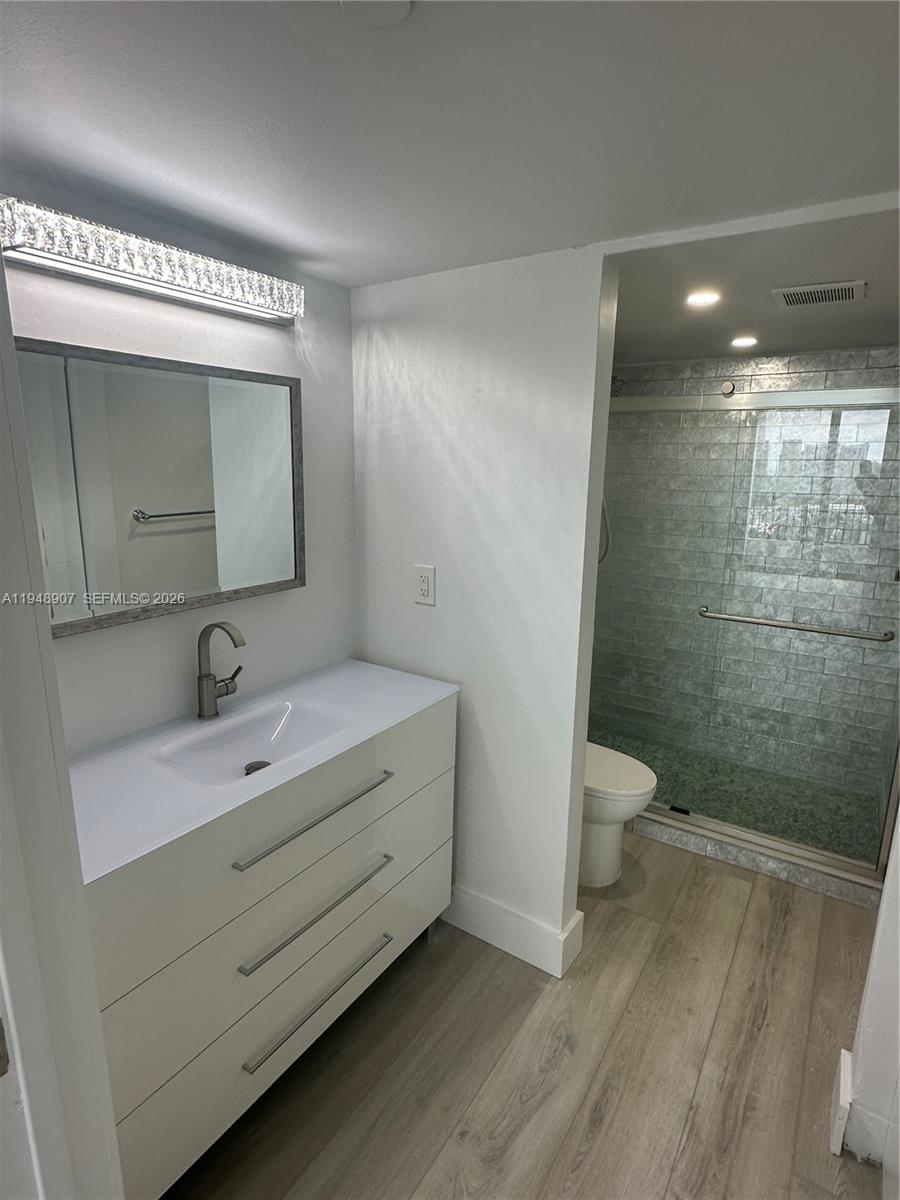 555 Northeast 15th Street, Unit TSA Miami, FL 33132 - Photo 15 of 24 a bathroom with a sink a toilet and mirror