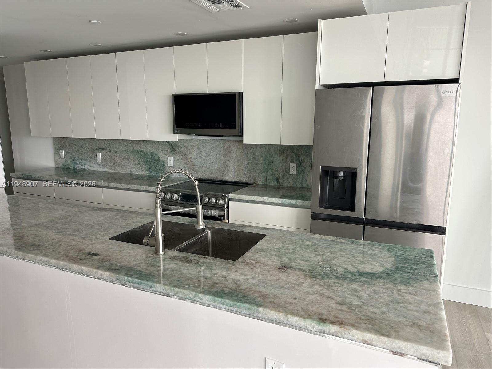 555 Northeast 15th Street, Unit TSA Miami, FL 33132 - Photo 8 of 24 a kitchen with a refrigerator and a sink