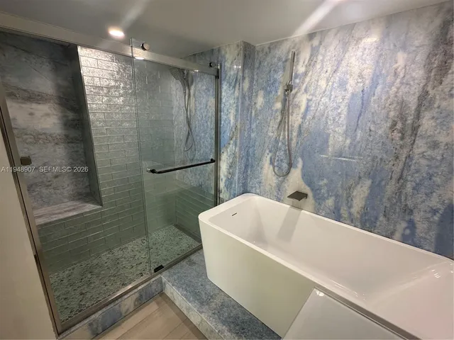 a bathroom with a bathtub and shower