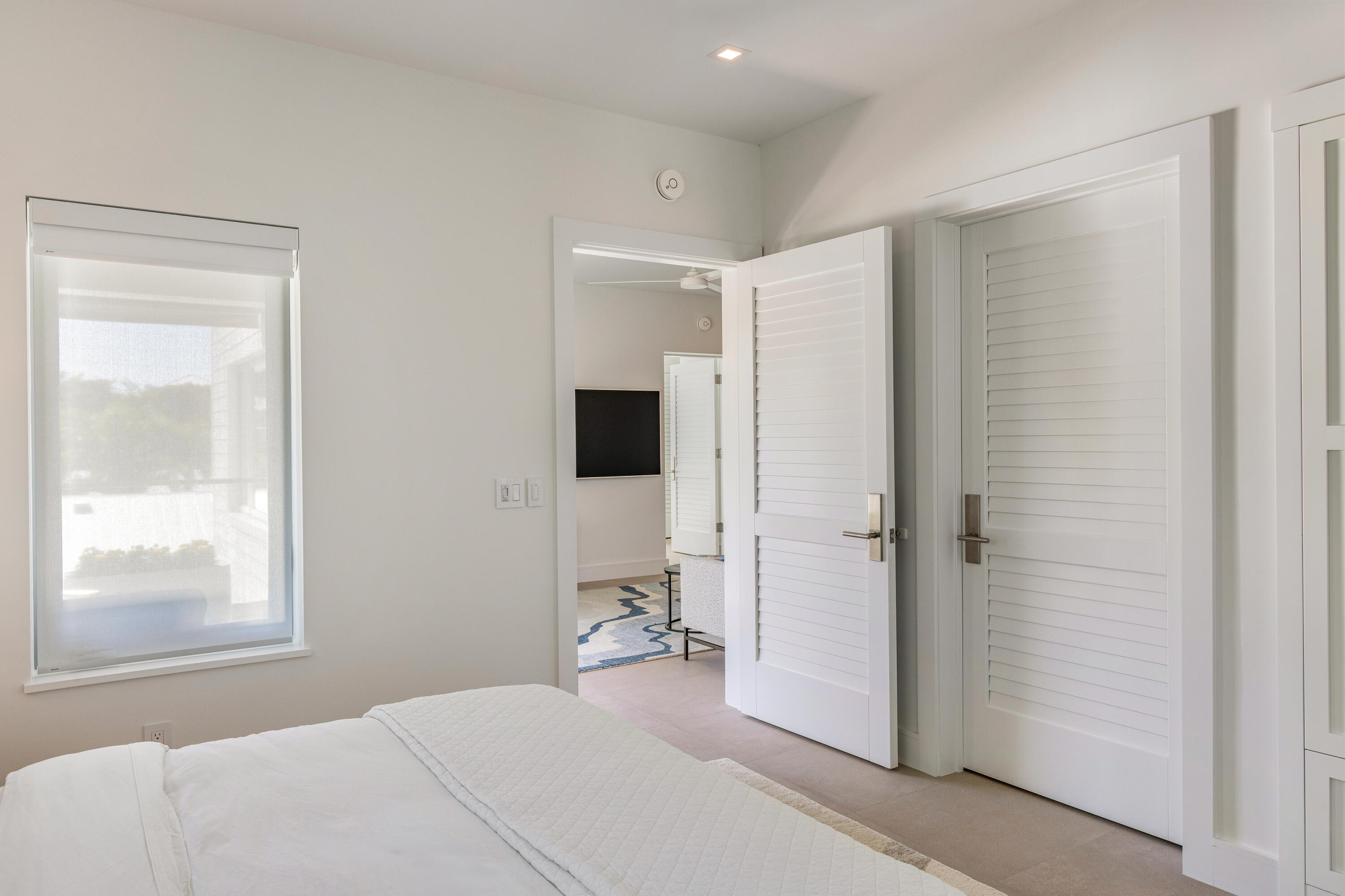 a bedroom with a bed and a flat screen tv