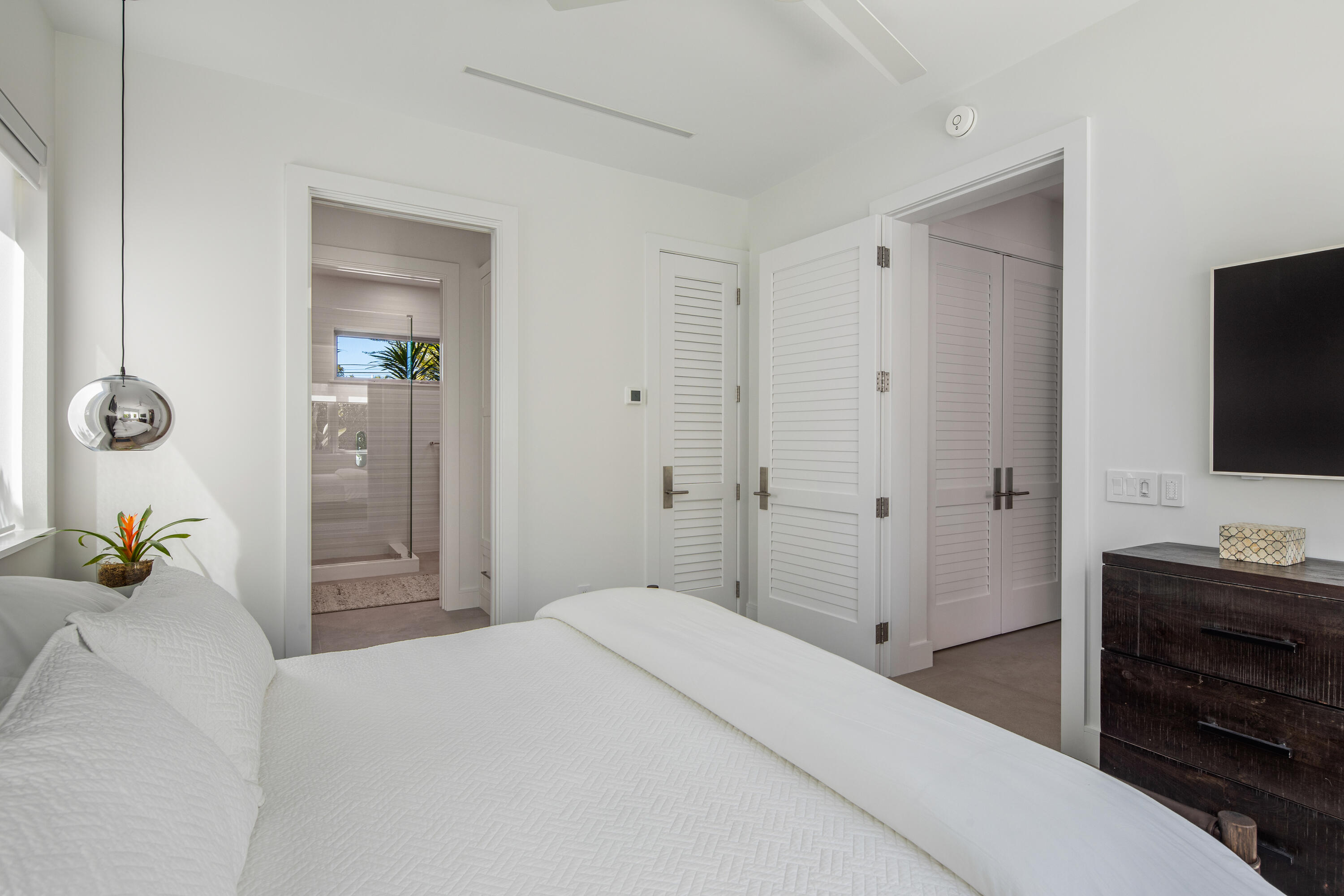 1614 Washington Street Key West, FL 33040 - Photo 41 of 59 a bedroom with a bed and a flat tv screen on dresser
