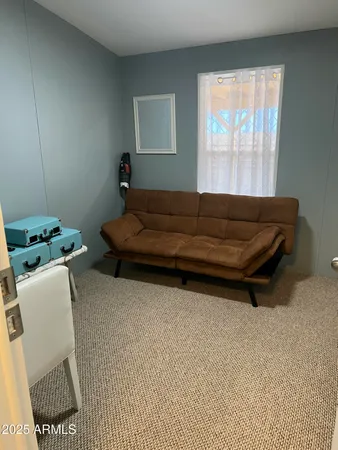 a bed sitting in a bedroom next to a window