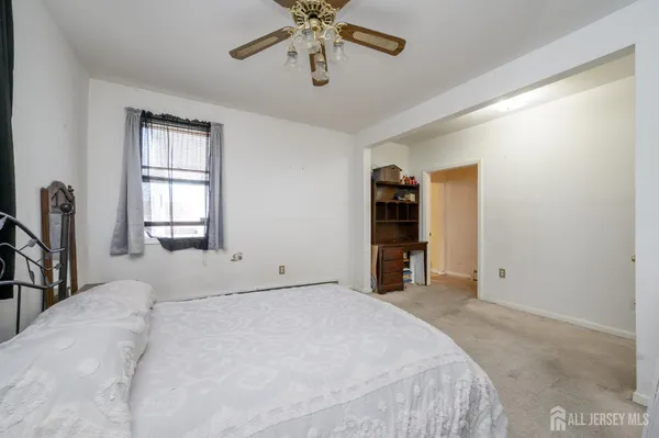 a bedroom with a large bed and a chandelier