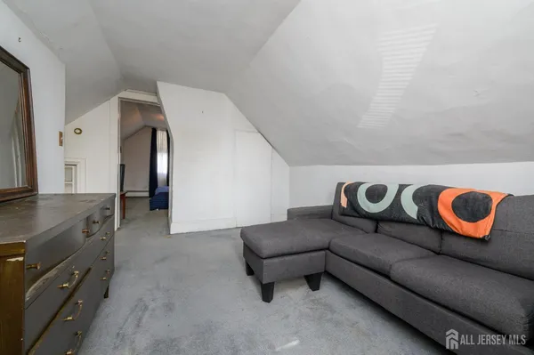 a living room with a couch and a sink