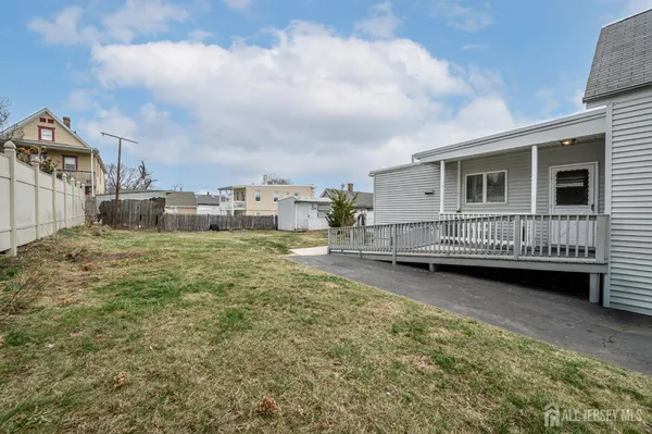 a view of a house with backyard and sitting area