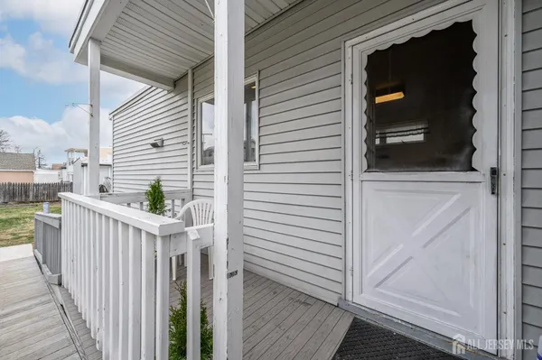 a view of a balcony with a door and wooden floor
