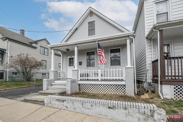 a front view of a house with a iron gate