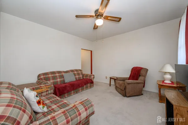 a living room with furniture and a lamp