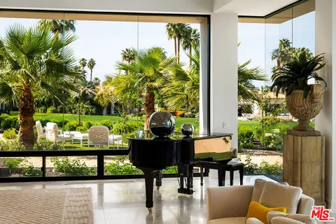 a view of a dining room with furniture a chandelier and wooden floor