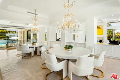 a living room with furniture a floor to ceiling window and floor to ceiling window