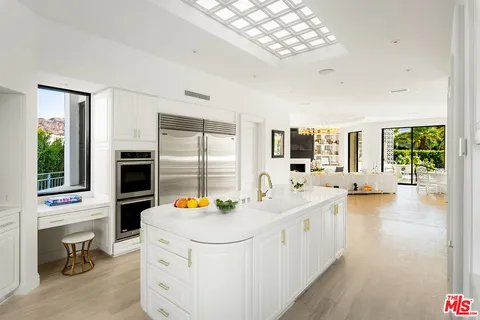 a bedroom with furniture and large windows