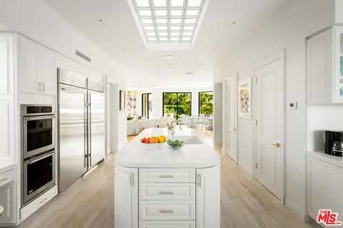 a living room with furniture and large windows