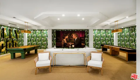 a living room with couches and a flat screen tv