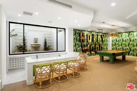 a living room with fireplace furniture and a large window